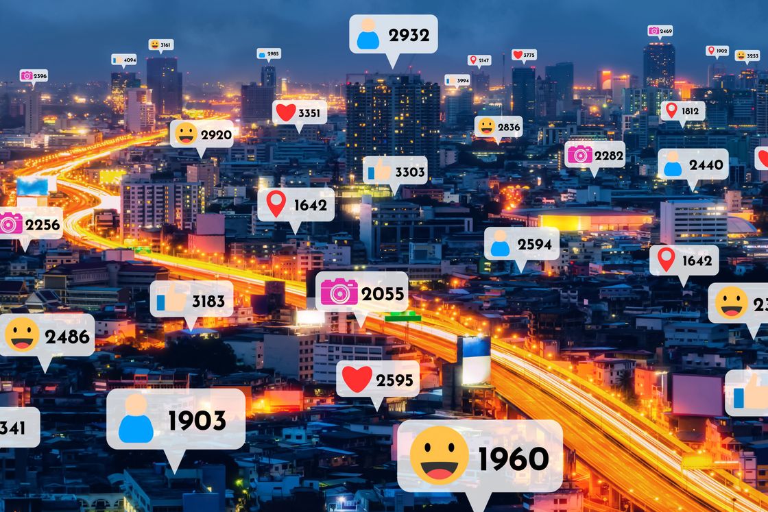 A city at night overlaid with social media engagement counts.